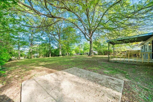 view of yard with a patio and a wooden deck