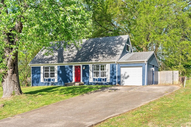 view of front facade with concrete driveway, a garage, a front lawn, and fence