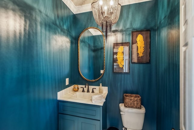 half bath with crown molding, a notable chandelier, toilet, and vanity