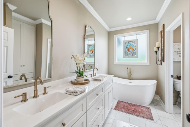 full bathroom featuring double vanity, a freestanding tub, ornamental molding, toilet, and a sink