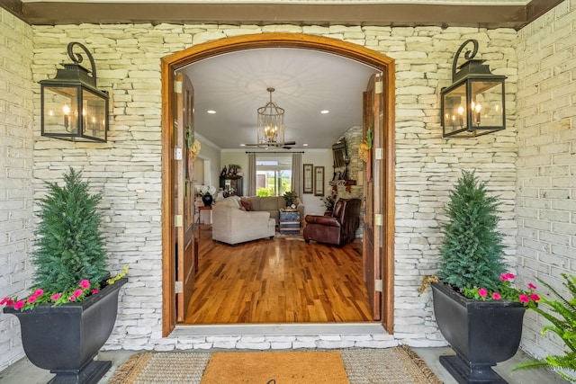 entrance to property featuring brick siding and covered porch