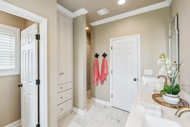 full bath with baseboards, a sink, marble finish floor, and ornamental molding