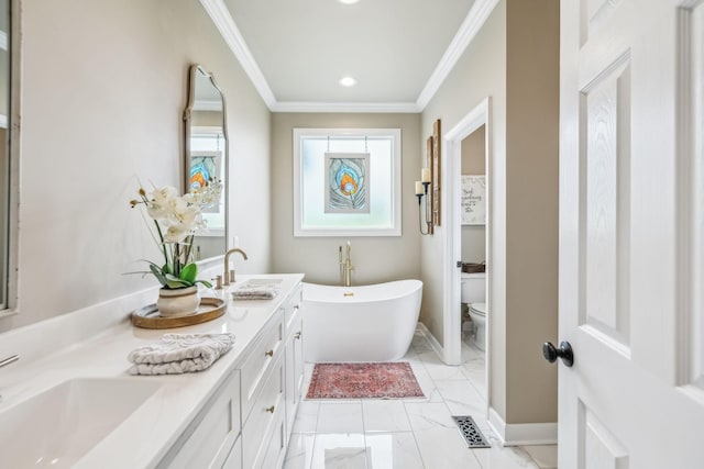 full bathroom featuring double vanity, a freestanding bath, a sink, toilet, and ornamental molding