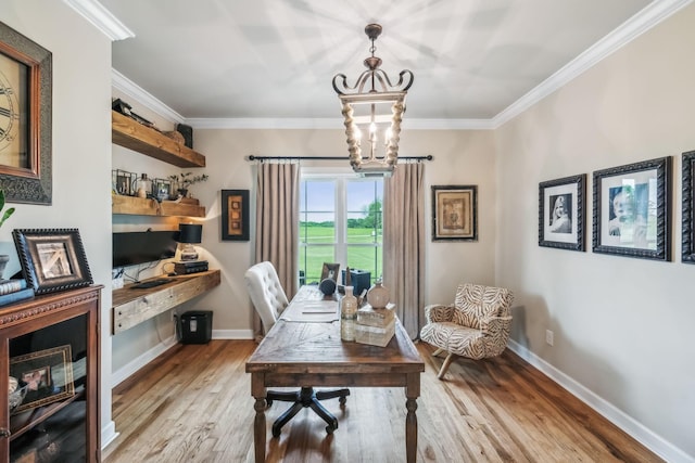 office featuring light wood-style floors, baseboards, ornamental molding, and a notable chandelier
