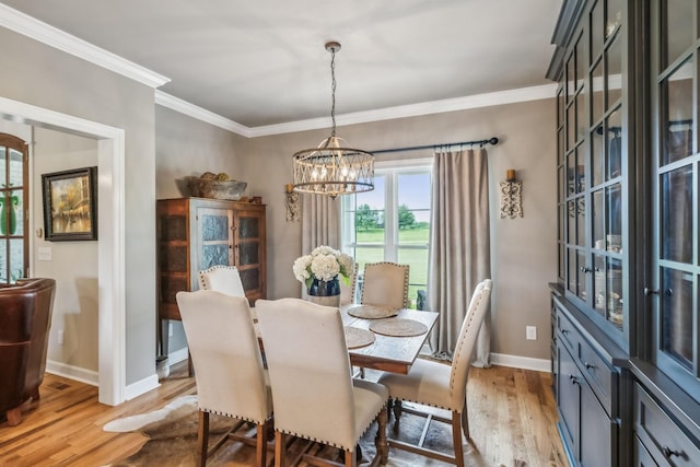 dining space featuring an inviting chandelier, baseboards, light wood-type flooring, visible vents, and ornamental molding