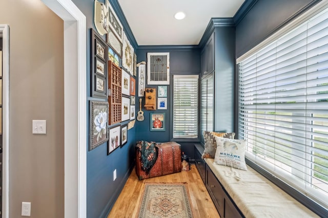 hall with crown molding, baseboards, recessed lighting, and light wood-style flooring