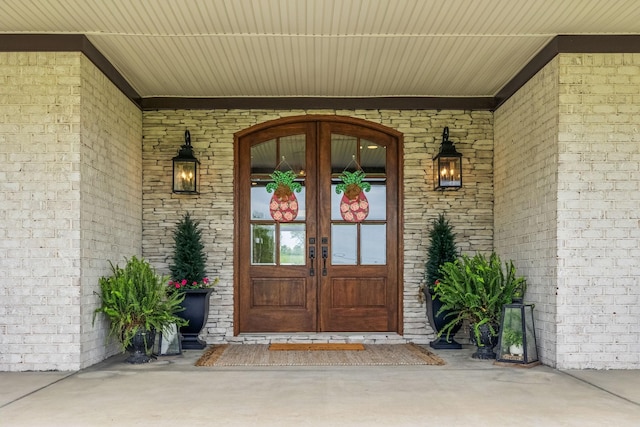 entrance to property with brick siding and french doors