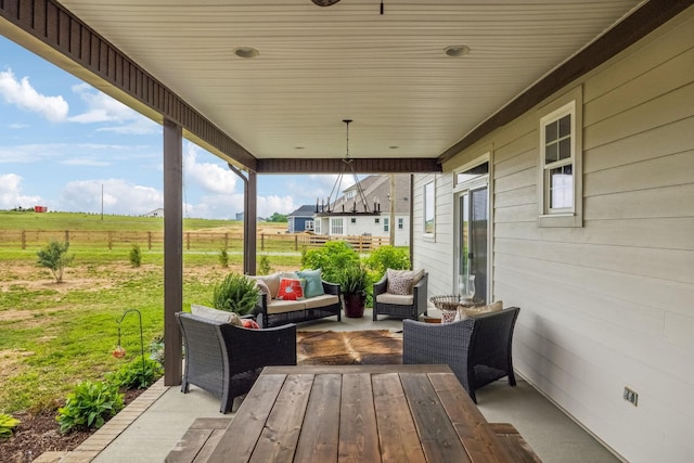 view of patio featuring outdoor lounge area and fence