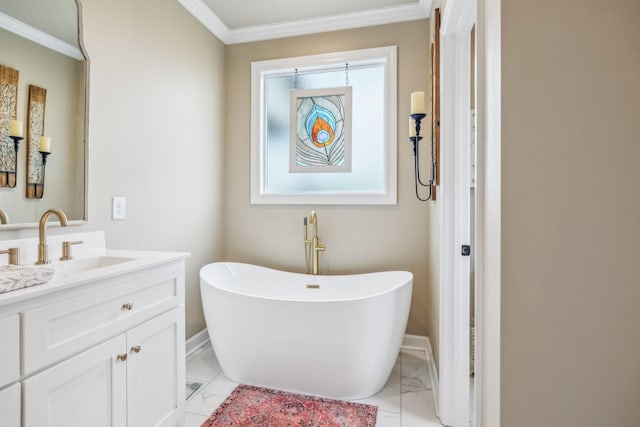 full bathroom with crown molding, vanity, marble finish floor, a freestanding tub, and baseboards