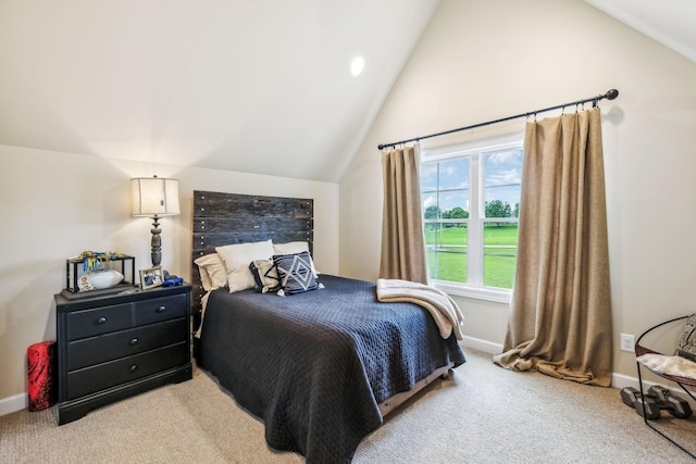 carpeted bedroom with baseboards and lofted ceiling