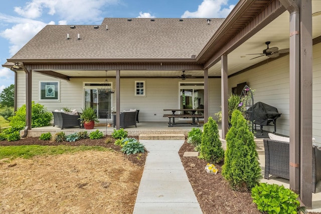 back of house with a patio, a ceiling fan, and roof with shingles