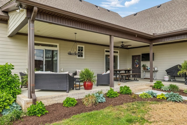 rear view of house featuring a shingled roof, ceiling fan, outdoor lounge area, and a patio area