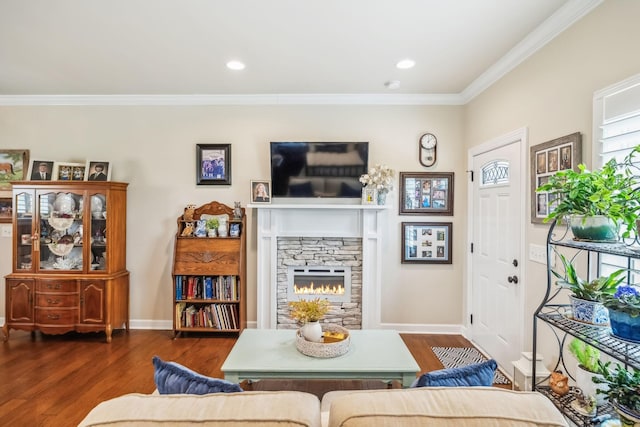 living room featuring a stone fireplace, ornamental molding, dark wood finished floors, and baseboards