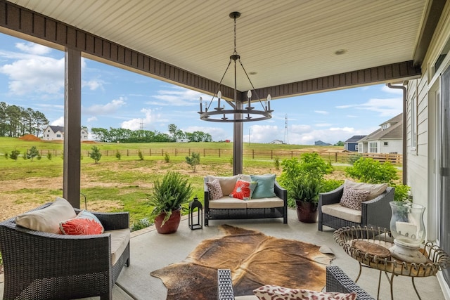 view of patio / terrace featuring fence, a rural view, and outdoor lounge area