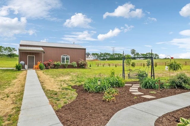 view of yard featuring fence and an outbuilding