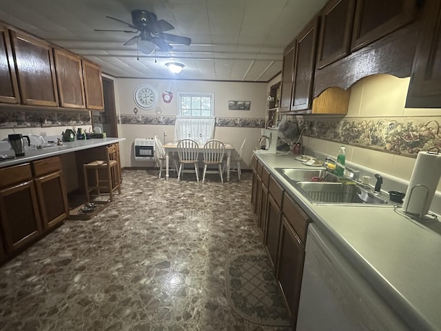 kitchen featuring a sink, heating unit, ceiling fan, light countertops, and dishwasher