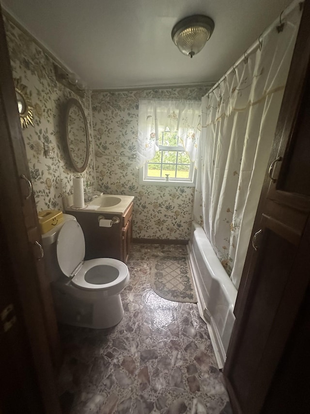 bathroom featuring toilet, wallpapered walls, shower / tub combo, and vanity