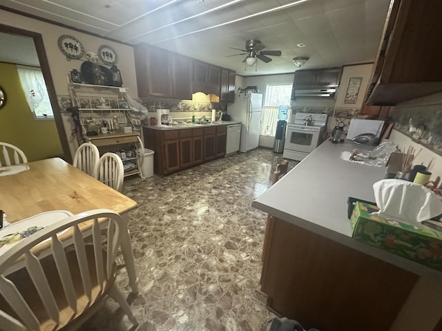 kitchen with a sink, ceiling fan, white appliances, ventilation hood, and light countertops