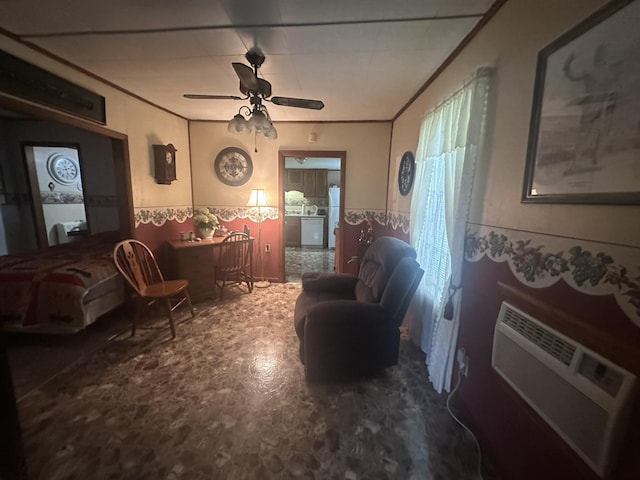 living area with a ceiling fan, a wainscoted wall, crown molding, and a wall mounted air conditioner
