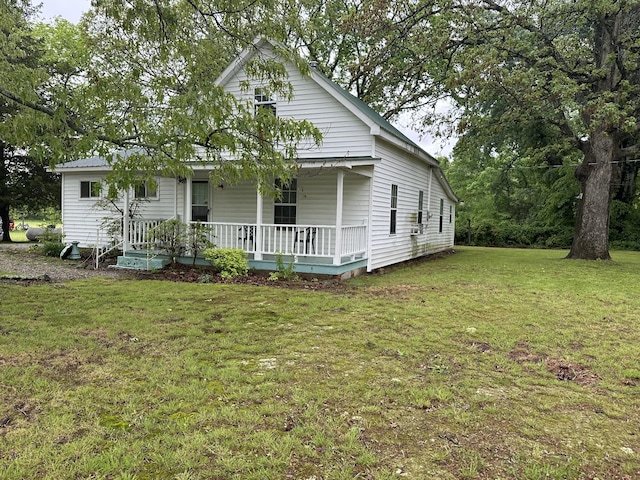view of front of home with a porch and a front lawn