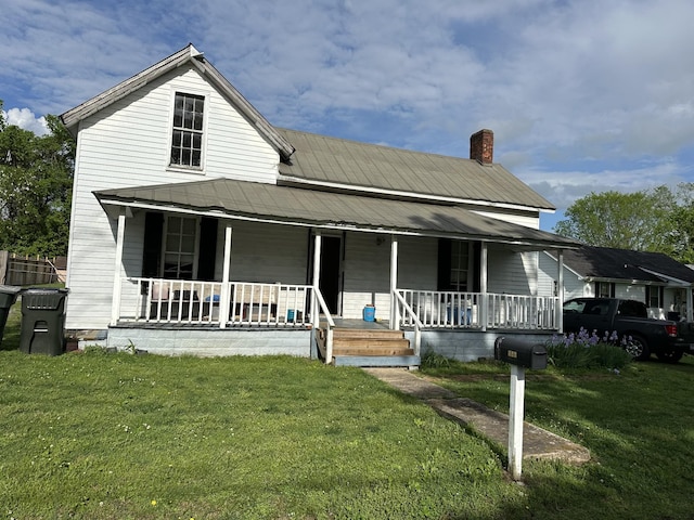 423 Anderson St, Gallatin, TN 37066 - farmhouse inspired home featuring a porch, a front yard, and a chimney