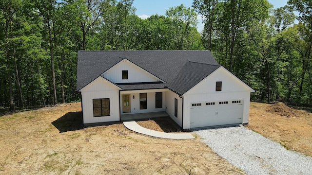 2775 Mayne Trace Rd, Waverly, TN 37185 - modern farmhouse style home featuring a porch, driveway, a shingled roof, and a garage