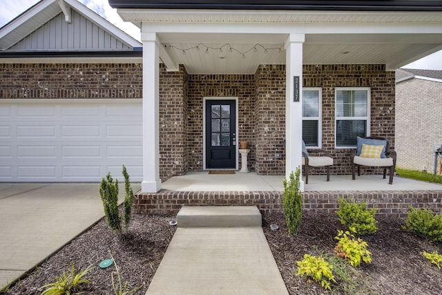 2137 Creekland View Blvd, Nashville, TN 37207 - property entrance featuring brick siding, a porch, driveway, and an attached garage
