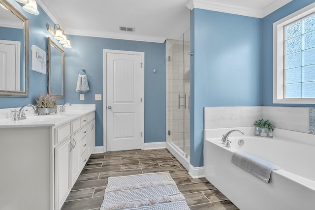 bathroom featuring visible vents, a shower stall, a bath, and a sink