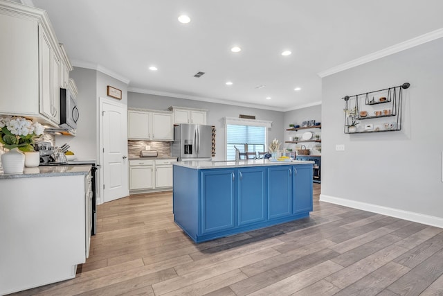 kitchen featuring blue cabinetry, stainless steel appliances, crown molding, and light wood-style floors