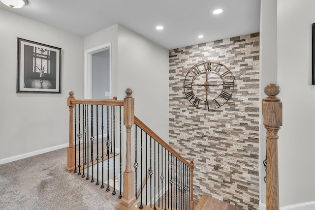 hall featuring recessed lighting, an upstairs landing, and baseboards