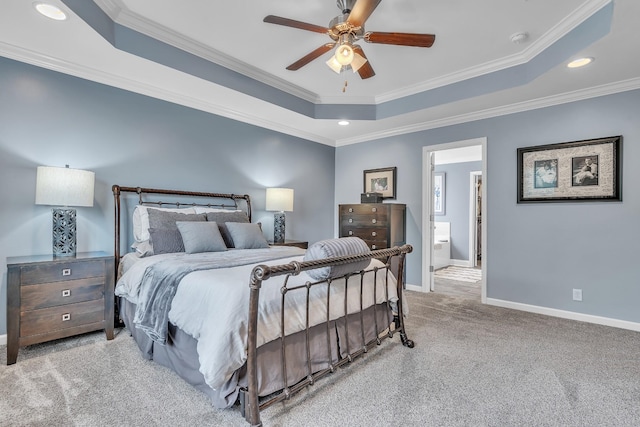 bedroom with a tray ceiling, baseboards, recessed lighting, ornamental molding, and carpet