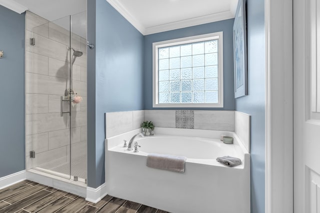 full bath featuring a stall shower, wood finish floors, ornamental molding, and a bath