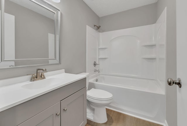bathroom with toilet, vanity, bathing tub / shower combination, and wood finished floors