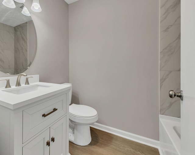 full bath with toilet, wood finished floors, vanity, and baseboards