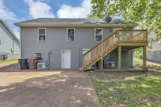 rear view of property with a wooden deck, ac unit, and stairs