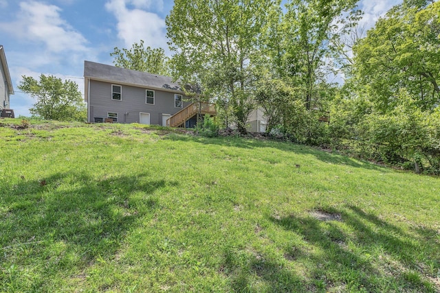 view of yard with stairway and a deck