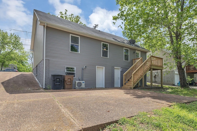 back of house featuring a deck, stairs, and ac unit