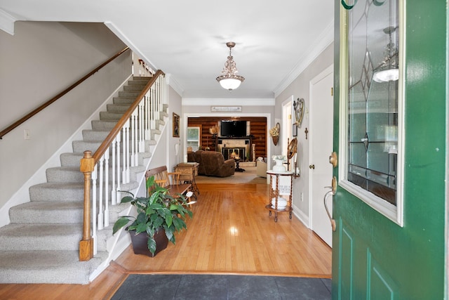 209 Green Valley Blvd, Franklin, TN 37064 - tiled entrance foyer with stairway, crown molding, and a glass covered fireplace