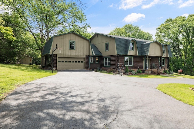 209 Green Valley Blvd, Franklin, TN 37064 - view of front of property featuring an attached garage, a gambrel roof, log exterior, a front yard, and driveway