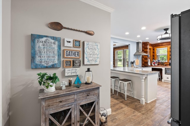 209 Green Valley Blvd, Franklin, TN 37064 - bar featuring crown molding, wall chimney exhaust hood, freestanding refrigerator, recessed lighting, and stainless steel microwave