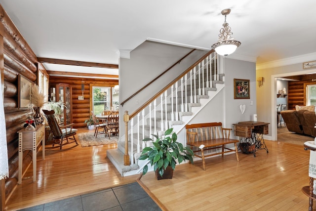 209 Green Valley Blvd, Franklin, TN 37064 - entrance foyer with crown molding, log walls, stairs, and hardwood / wood-style floors