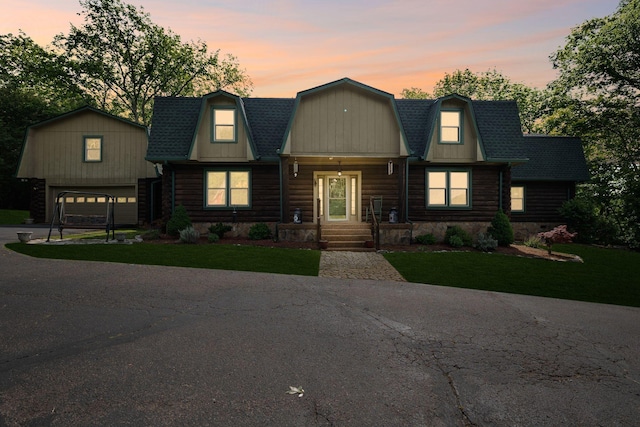 209 Green Valley Blvd, Franklin, TN 37064 - view of front of home featuring an outdoor structure, a garage, a gambrel roof, a lawn, and driveway