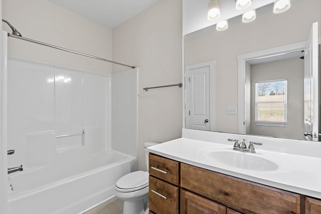bathroom with shower / washtub combination, toilet, and vanity