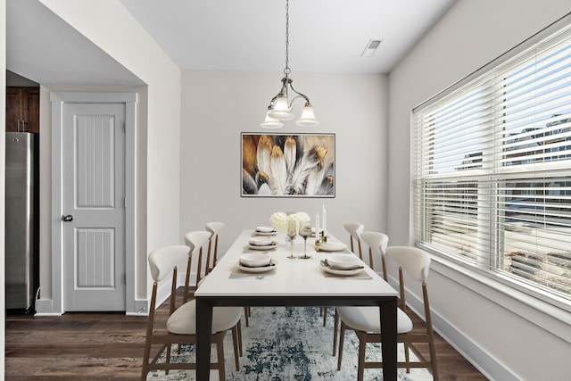 dining space featuring baseboards, visible vents, and dark wood-style floors