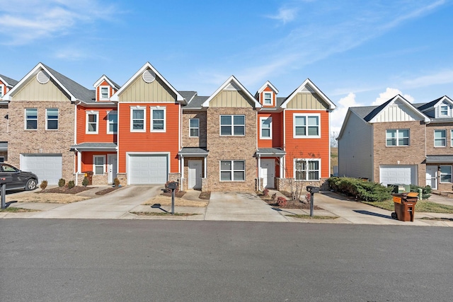 townhome / multi-family property with driveway, board and batten siding, an attached garage, and stone siding