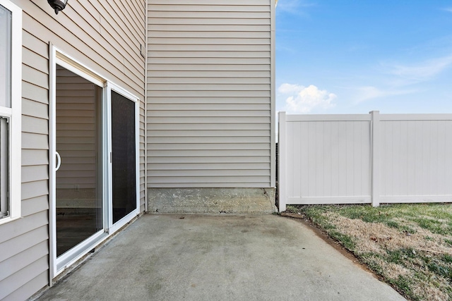 view of patio / terrace featuring fence