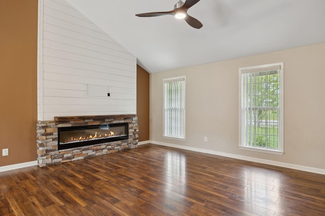 unfurnished living room with wood finished floors, a fireplace, baseboards, a ceiling fan, and lofted ceiling