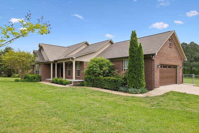 single story home with concrete driveway, a front yard, and brick siding