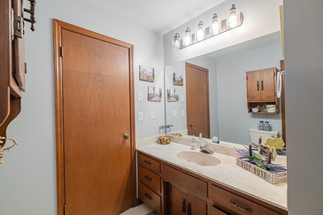 bathroom with toilet and vanity