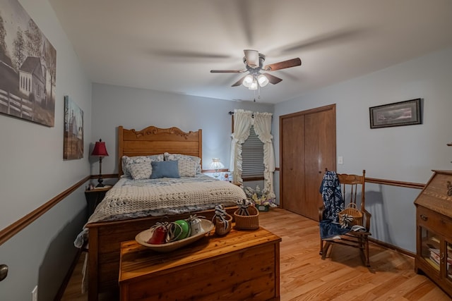bedroom with a ceiling fan, light wood finished floors, and a closet